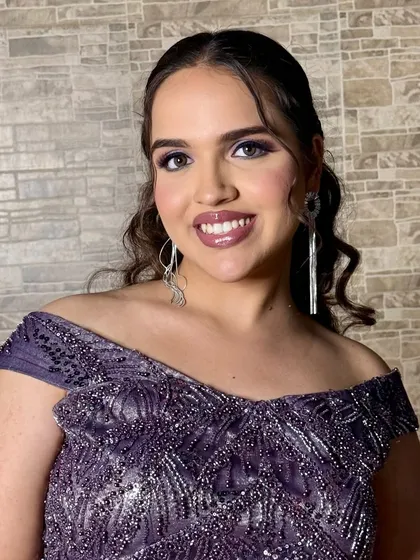 Sangeet glam that speaks soft elegance. This look features a glossy lip, radiant skin, and bold purple lids for a touch of drama.