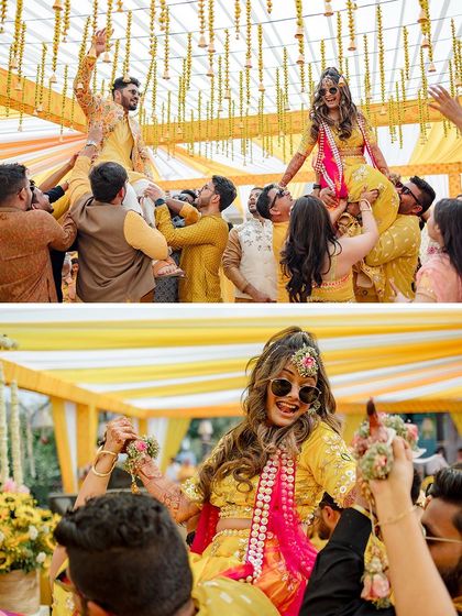 The bride and groom being lifted on the shoulders of their friends and family, a high-energy and unforgettable Haldi moment.