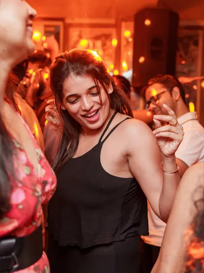 A guest smiling and dancing, caught in a moment of pure joy.