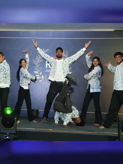 The full crew in a high-energy pose. This photo captures the mix of styles in our performance, from contemporary Bollywood to street-style freezes, all part of our guest showcase for a corporate awards night.