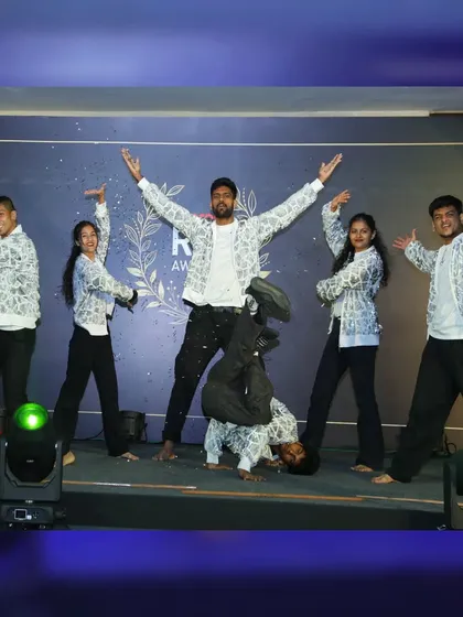 The full crew in a high-energy pose. This photo captures the mix of styles in our performance, from contemporary Bollywood to street-style freezes, all part of our guest showcase for a corporate awards night.