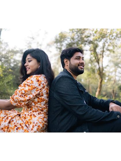 Sitting back-to-back in a peaceful grove, this shot captures a moment of shared serenity and happiness.