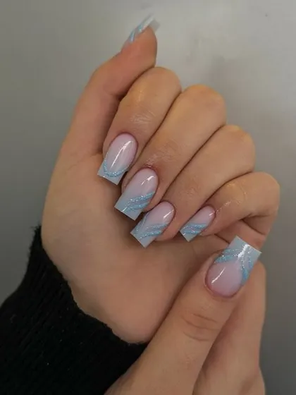 Another look at the icy blue glitter tip design, perfect for a winter-themed event.