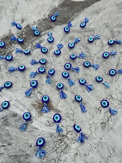 An artistic flat-lay of 40 evil eye keychains. These make for fantastic and memorable return gifts for any celebration.