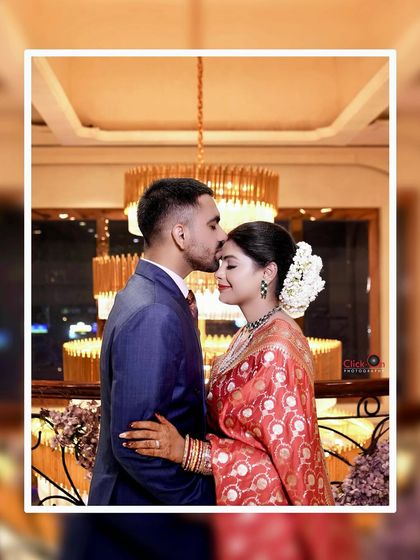 A tender moment from the reception, with the groom kissing the bride's forehead. These are the cherished, quiet moments we aim to capture.