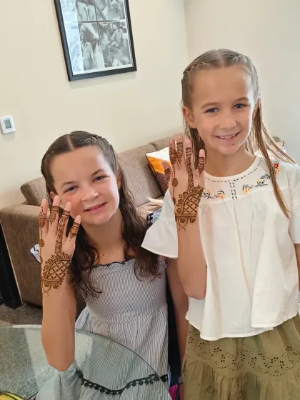 Two happy sisters from the UK, showing off their beautiful Indian henna.