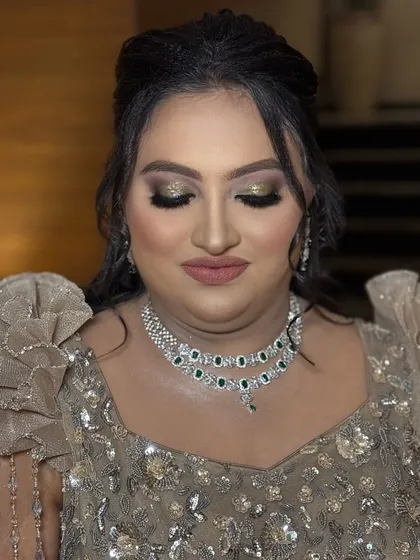 A close-up of the glittery gold and green eye makeup for this reception look. The colors are chosen to perfectly match the embellishments on her beautiful gown.