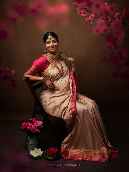 Dressed in a beautiful silk saree, this expectant mother is the picture of grace. The floral elements add a touch of softness and color to this traditional maternity portrait.