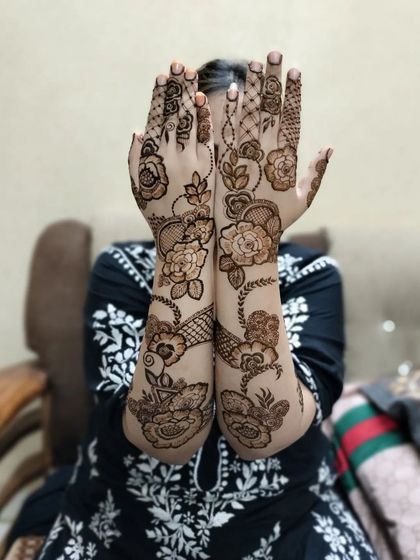 A lovely pose showing how a flowing floral design looks when the hands are brought together. The patterns connect beautifully across the arms.