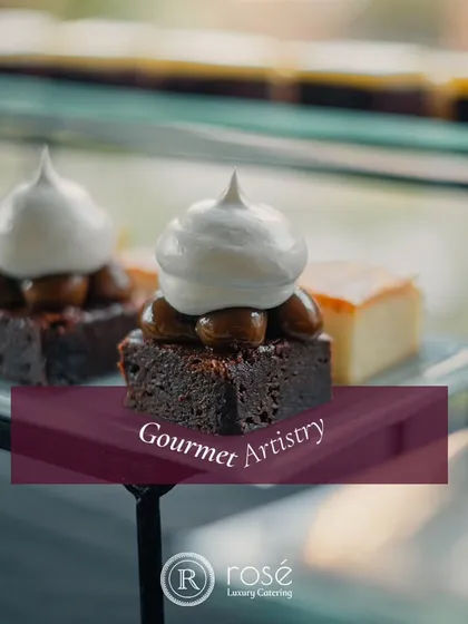 A close-up of a rich, fudgy brownie topped with meringue. This image, labeled "Gourmet Artistry," reflects our dedication to creating unforgettable dessert experiences that are a feast for the senses.