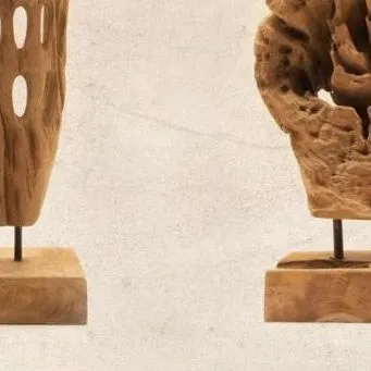 A close-up view of two artifacts, highlighting the rich texture and grain of the aged teak wood. These pieces are perfect for enhancing a shelf or console table.