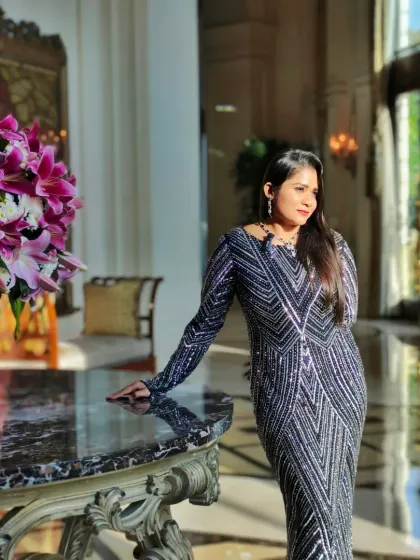 A moment of poise amidst the beautiful decor of The Leela Palace. The ambiance of an event is key, and I ensure my presence complements it perfectly.