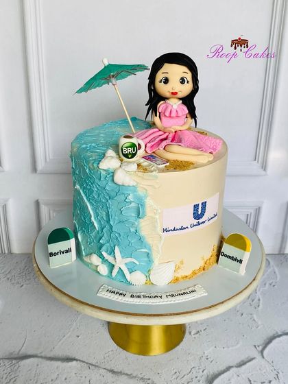 A unique cake telling a personal story of travel and work. This design combines a beach theme with a Hindustan Unilever logo and location markers for Borivali and Dombivli.