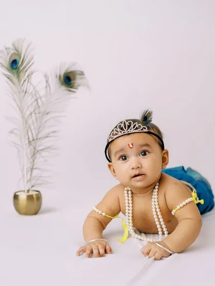 A baby boy dressed as Little Krishna for Janmashtami, looking absolutely divine during his themed photoshoot.
