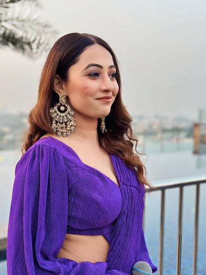 A close-up of my purple saree look. The statement earrings perfectly complemented the bold color of the outfit.