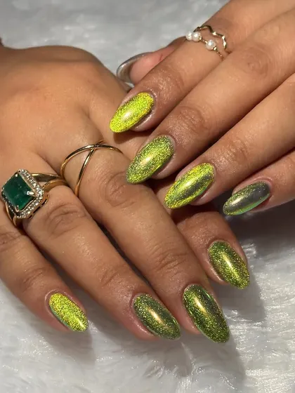 Make a statement with these mesmerizing cat-eye nails in a vibrant lime green. This magnetic effect is a huge trend for festive looks.