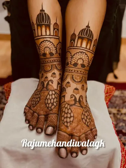 A bride's look is complete only when her feet are adorned with beautiful mehendi. This is a symmetrical design with peacocks and architectural domes, creating a look that is as grand and detailed as the hand mehendi.
