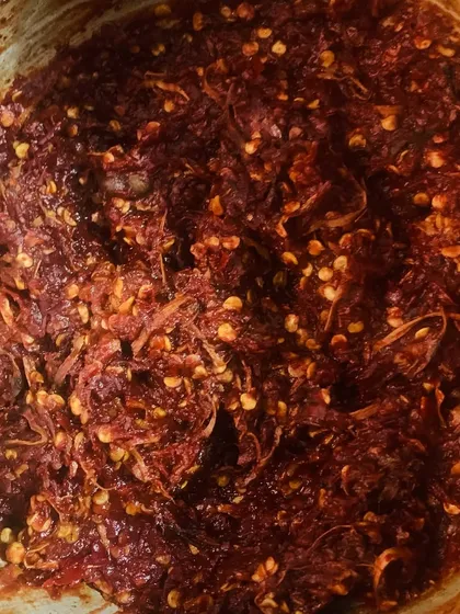 This is Etsu Molu, our traditional red chilli chutney. It's fiery and full of flavour, made by pounding together fresh king chillies, garlic, and other spices. A little bit of this goes a long way to spice up any meal.
