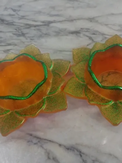 This pair of orange and gold glitter T-light holders features a contrasting green rim for a unique, handcrafted look. They show how I can play with color combinations to create something special for your event.