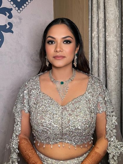 A close-up of the sleek open hair and glamorous makeup.