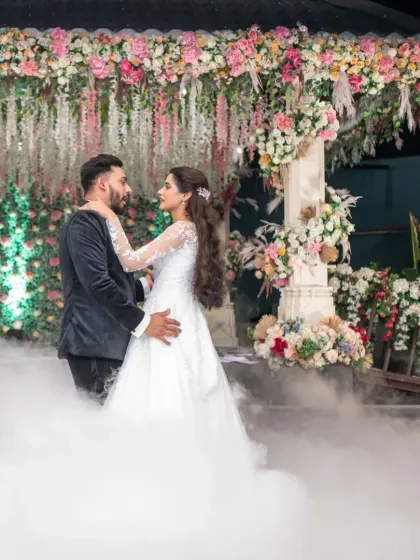 A romantic moment during the first dance. The couple looks lost in their own world, surrounded by a dreamy cloud of smoke.