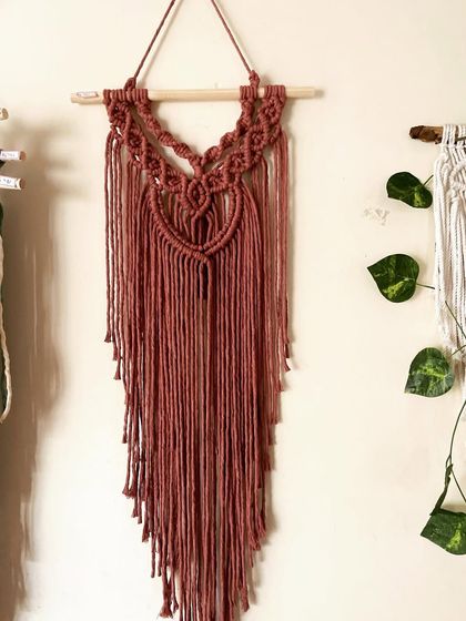 This minimal wall decor piece in a dusty rose color is perfect for adding a touch of handmade charm without overwhelming a space.