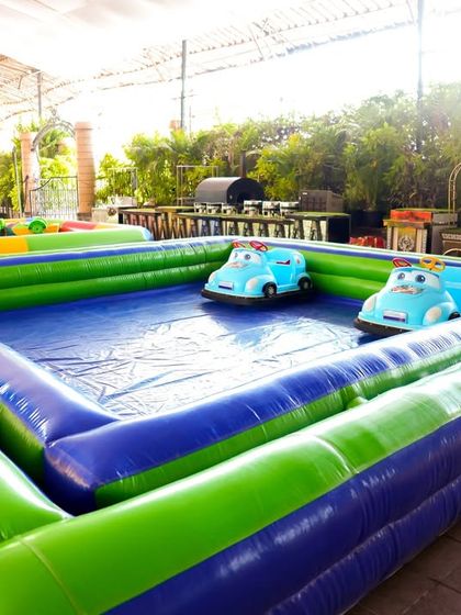 An inflatable bumper car arena where kids can safely zoom around and bump into each other in small, easy-to-operate cars.