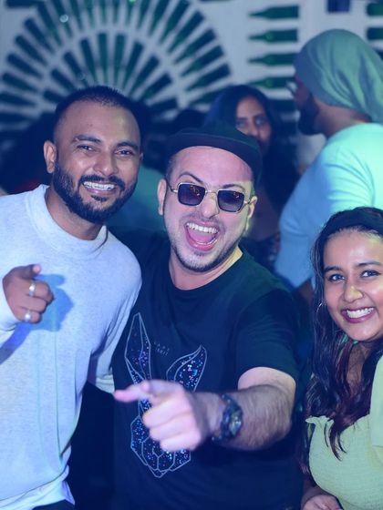 Sharing a laugh and a great moment with the crowd. It's all about creating a friendly, high-energy environment where everyone feels like part of the party.