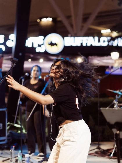 Another angle of me getting lost in the music on stage. The hair whip is a signature move when the beat drops during a Moksha All Stars performance.