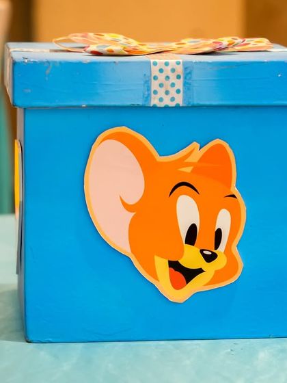 A close-up of a themed box decorated with Jerry's face, part of the party's detailed decor.