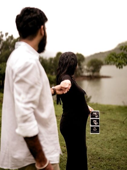 A creative "follow me" shot where the mom-to-be leads her partner, holding the sonogram pictures. It beautifully connects their past, present, and future.