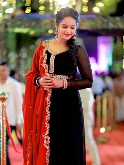 A candid, smiling shot of Duniya Rashmi, capturing her natural elegance.
