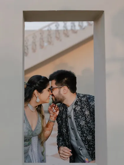 A quiet, stolen moment between the couple during their Haldi festivities, framed through a window for an intimate and personal feel.