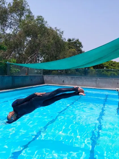 A moment of stillness. A good dive is about achieving a perfect streamline to cut through the water with minimal resistance. Here, I'm demonstrating that initial entry position.