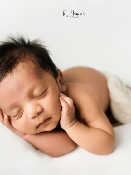 Sometimes, the most beautiful portrait is the simplest one. With a clean white backdrop, all the focus is on your baby's perfect, tiny features, from their soft hair to their peaceful expression.