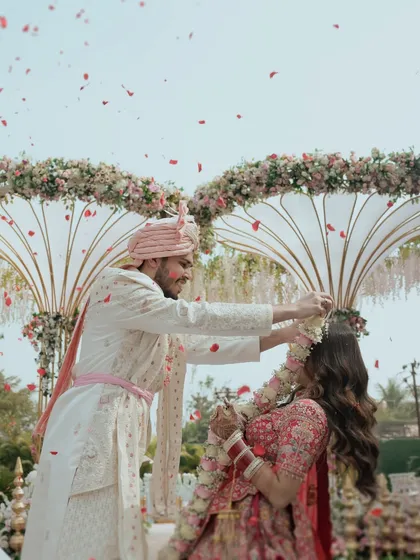 The pure joy of the Varmala ceremony. I focus on capturing the energy, the shower of petals, and the genuine smiles that make this tradition so special. This is a classic Indian wedding moment, frozen in time.