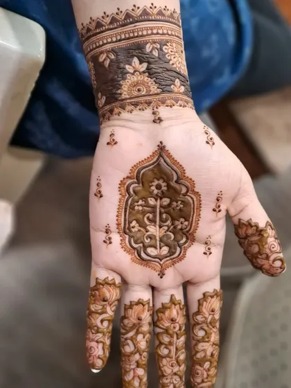 A single hand from the mughal-inspired set. This close-up shows the intricate floral work inside the central motif.