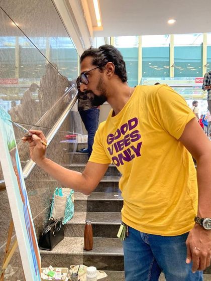 A close-up of me painting during the sustainability-themed art event.