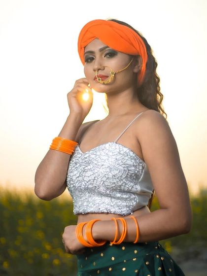 A closer view of the makeup for the patriotic concept shoot. Here you can see the detailed smokey eye, flawless base, and traditional nose ring, paired with an orange turban.
