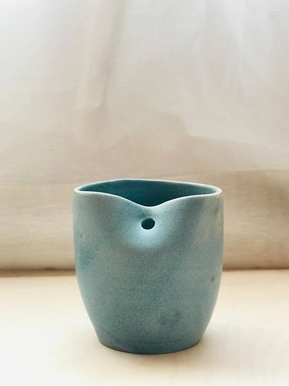 A front view of the "Sipura" cup. The minimalist design and calming color make it a perfect vessel for mindful moments.