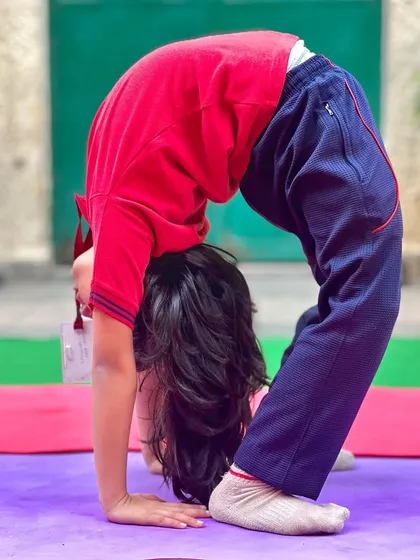 My baby star. This young student demonstrates a perfect Chakrasana (Wheel Pose) drop back, showing incredible spinal flexibility.