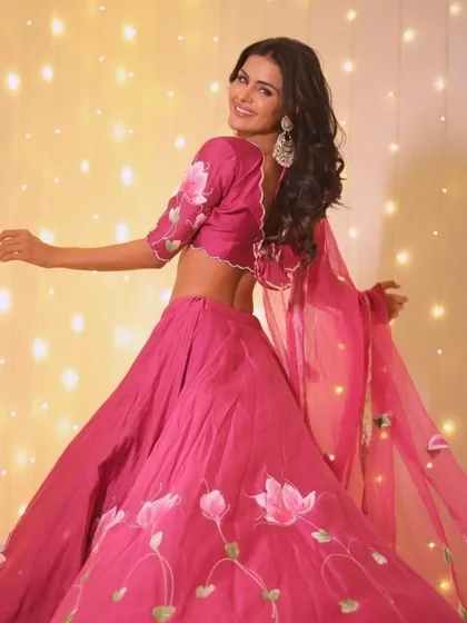 A soft touch of pink, a whole lot of glam. A full-length shot of Priyanka twirling in her beautiful pink lehenga.