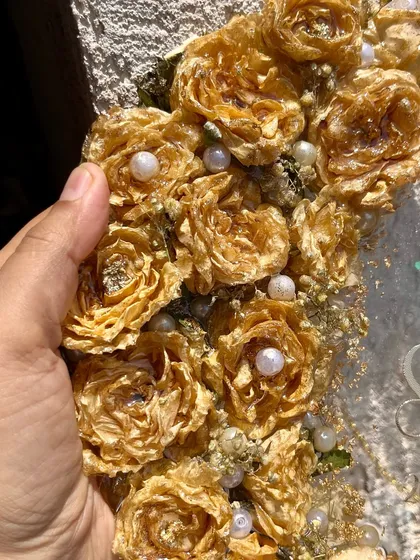 A close-up of the beautiful 3D preserved golden roses on a wall-hanging frame. The detail is exquisite, making it a true piece of art.