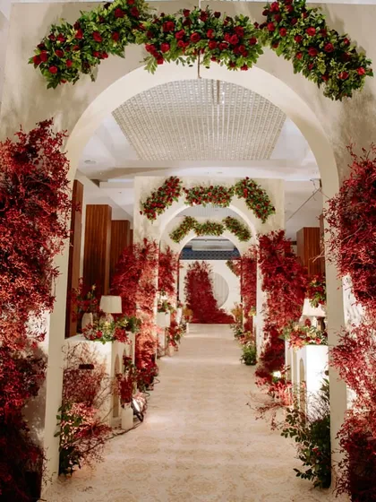The full view of the dramatic red and white entrance aisle, a breathtaking passageway for the couple and their guests.