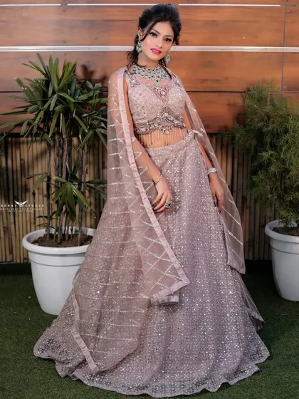 A dynamic full-length shot, capturing the movement and flow of the light, shimmery lehenga.