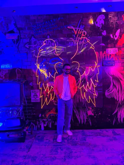 A stylish shot from a Goa after-party. The neon lights and graffiti wall set the perfect mood for a night that never ends.