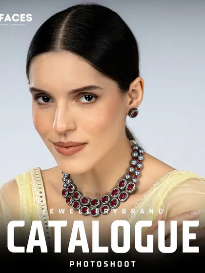 This shot features a modern necklace with ruby-colored stones. The model's direct look and clean background ensure the product is the star of the photo.