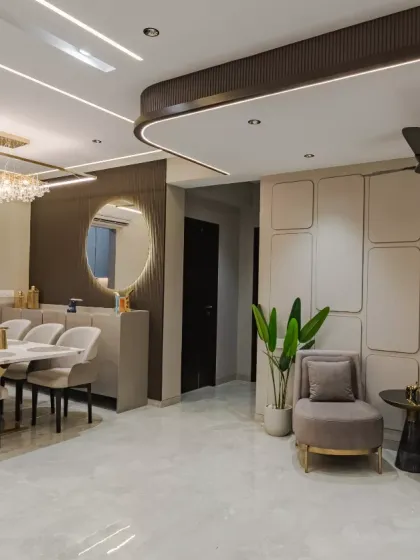 Minimalist elegance at its finest, featuring soft, geometric wall panelling that adds depth and subtle character to the space. The seamless integration of the dining and lounge areas, paired with curated decor and modern lighting, creates a sophisticated yet inviting ambiance.