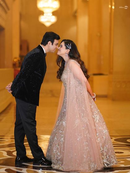 A playful and cute moment between the couple. Their almost-kiss and happy expressions make this a charming and memorable engagement photo.