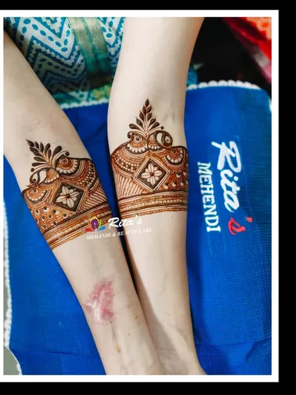 The startup bands on the arms for the engagement mehendi.